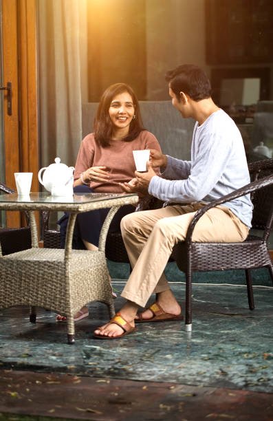 loving couple spending leisure time together while drinking coffee outdoors