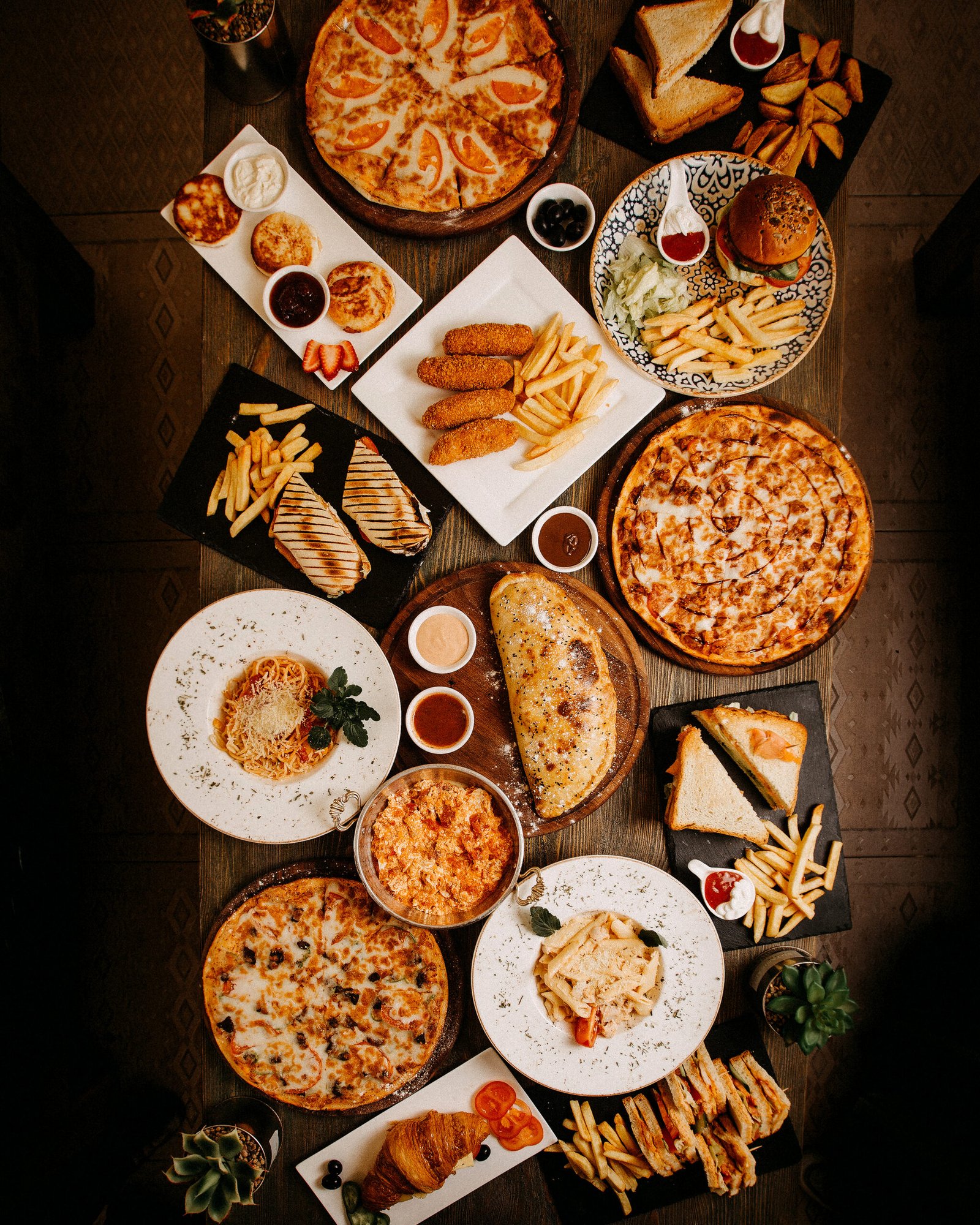 top view meals tasty yummy different pastries dishes brown surface